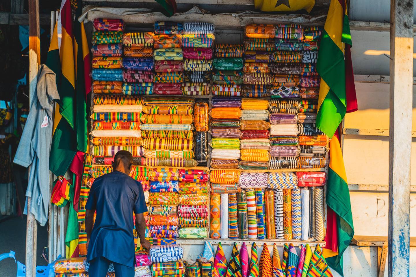 man standing in front of colorful cloth