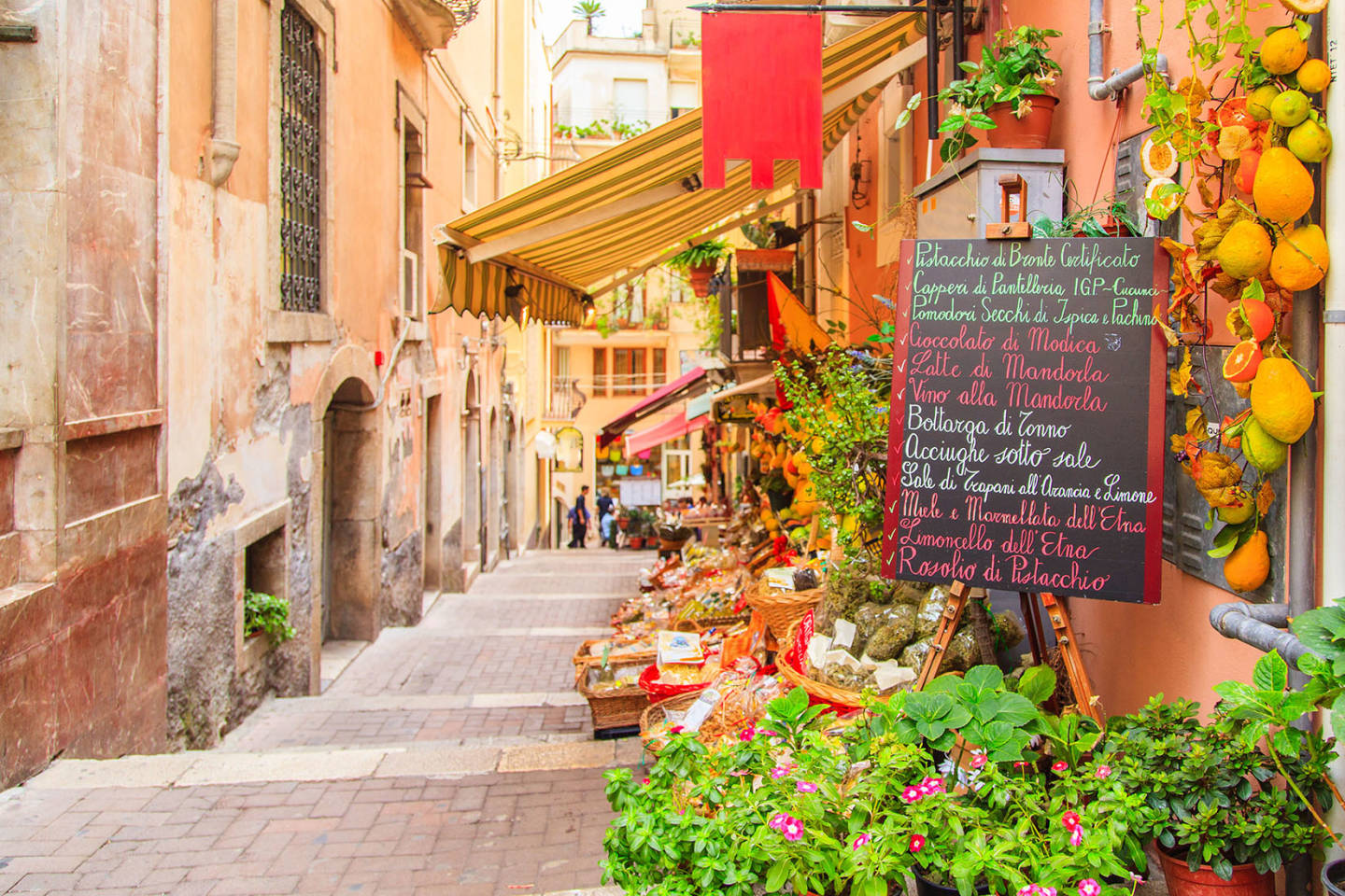 small street in Italy with cafe and flowers