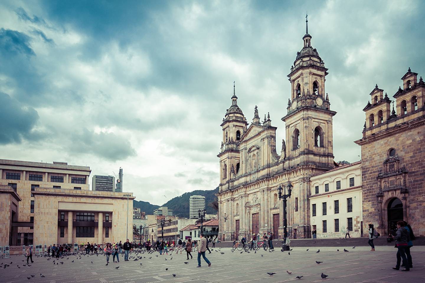 people walking across square by old church