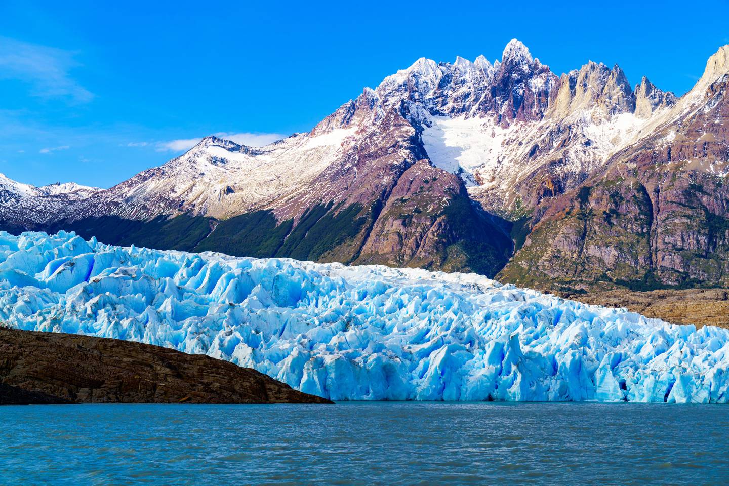 glacier on lake, mountains in background